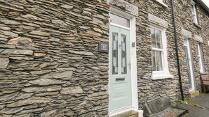 A stone building with a green door and a sign that reads "St Mary's Cottage, 11 Havellock Road."