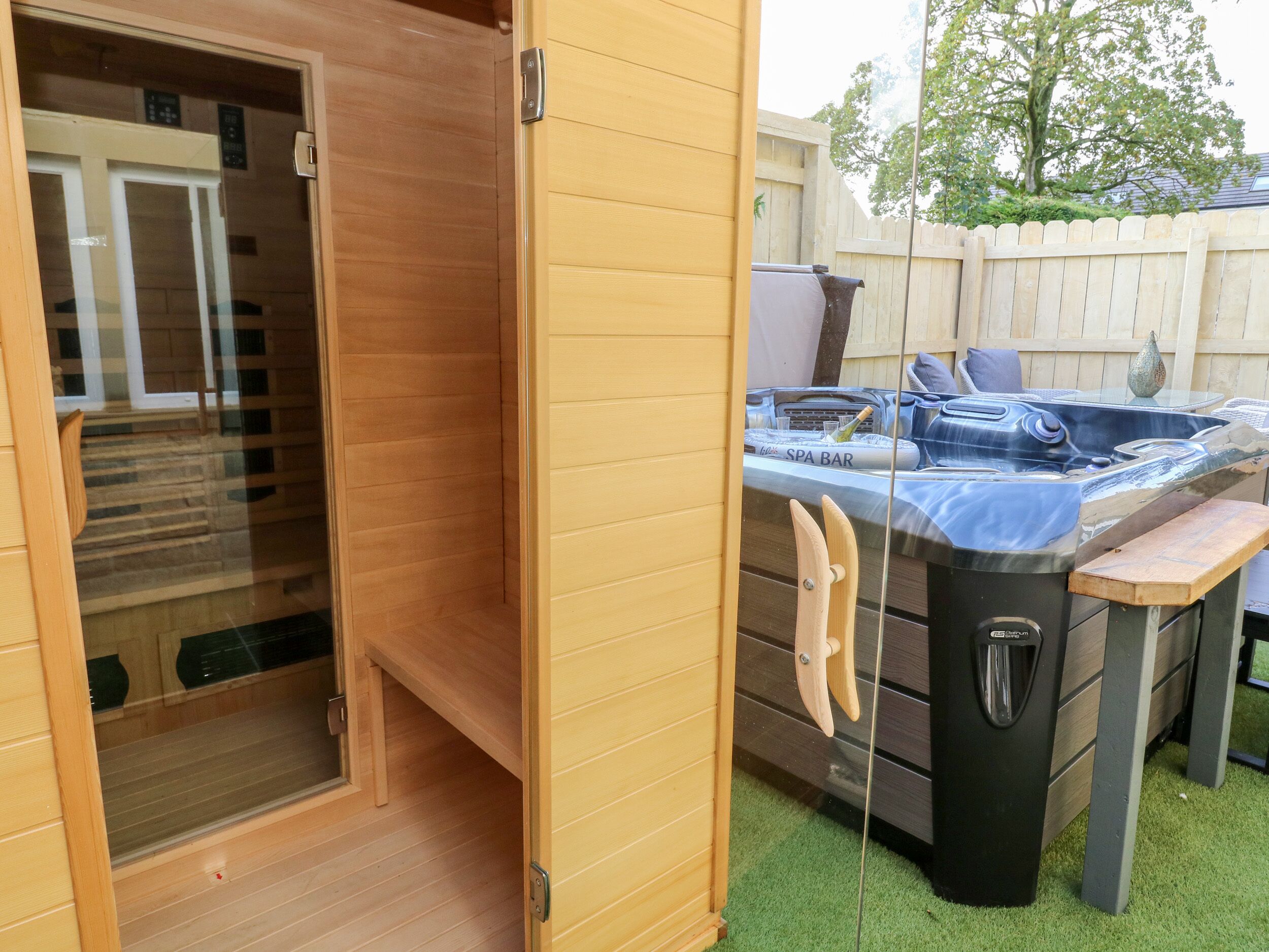 A wooden spa bar with a hot tub and a glass enclosure.