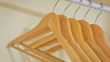 A wooden hanger rack with multiple hangers.