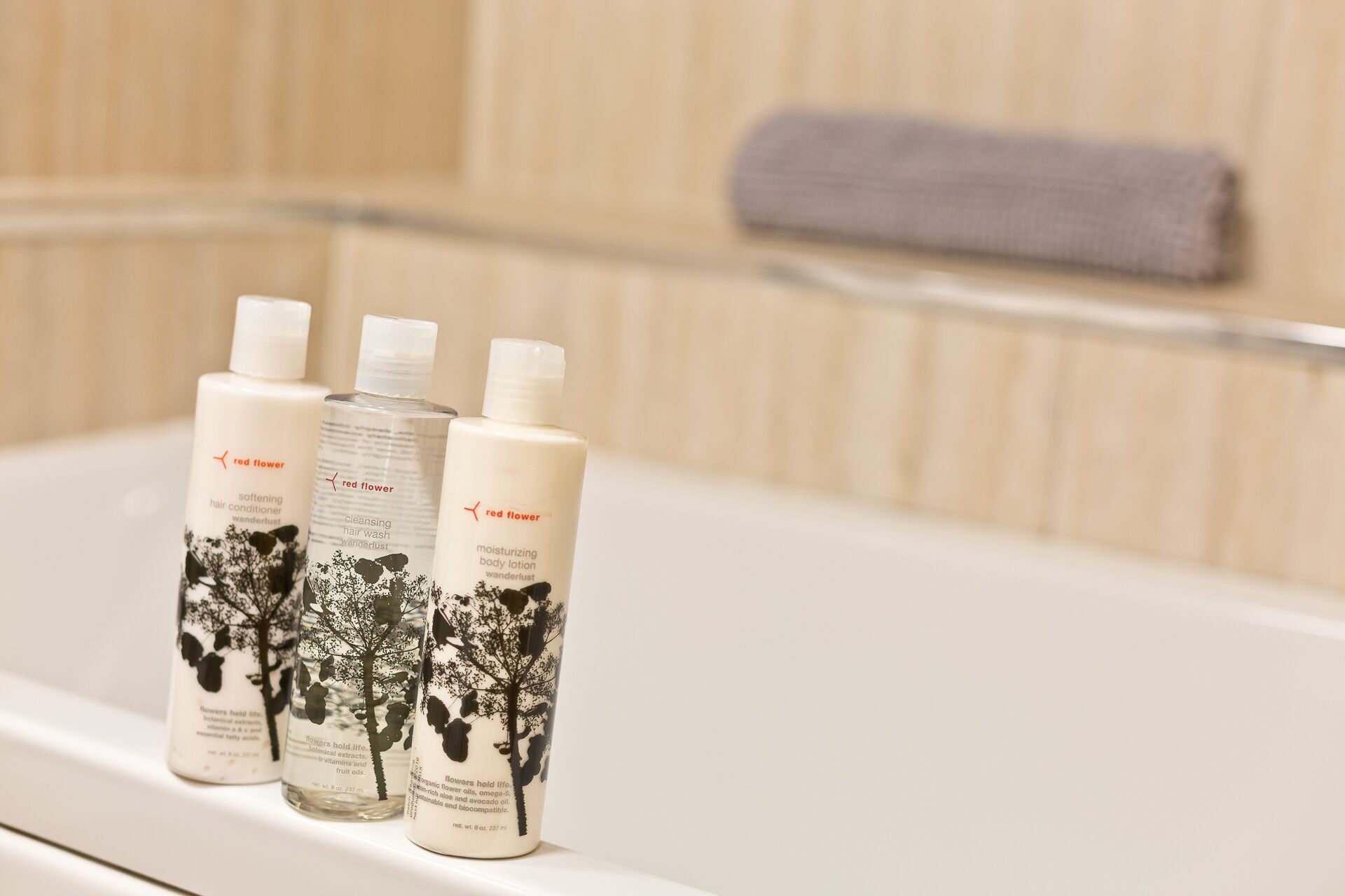 Three bottles of Red Flower products on a bathroom counter.