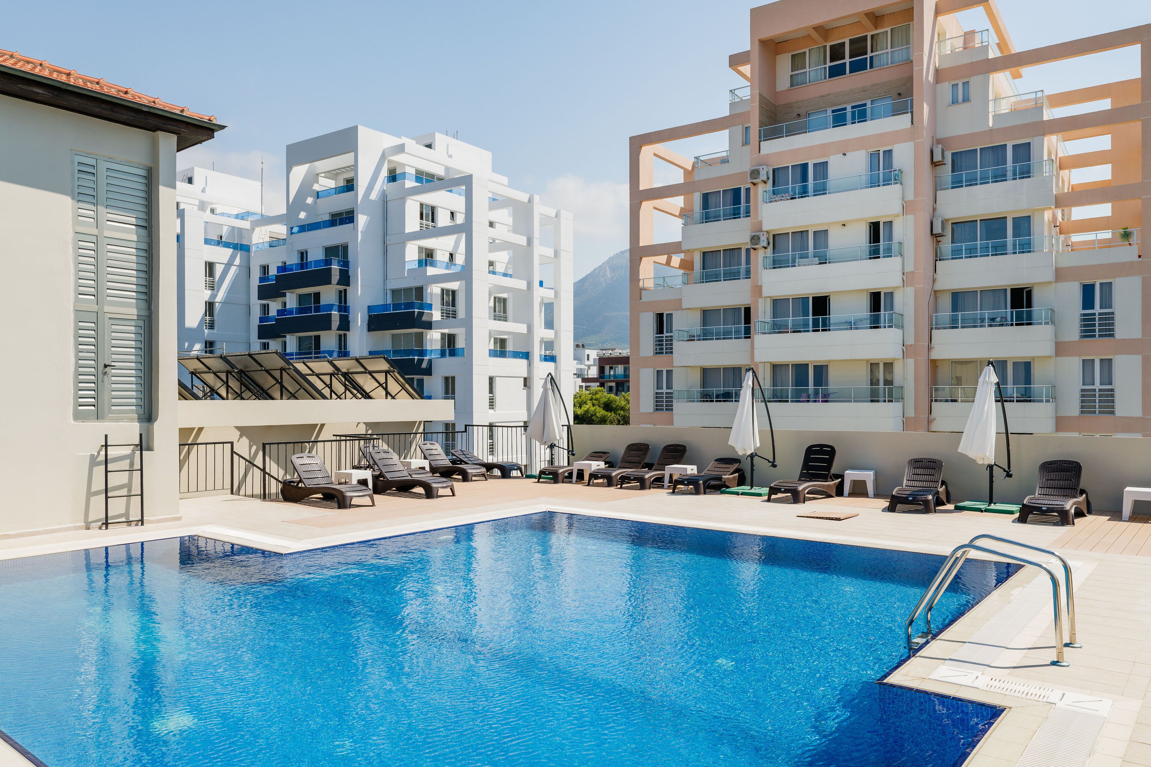 outdoor pool, open 8:00 am to 6:00 pm, pool umbrellas, pool loungers