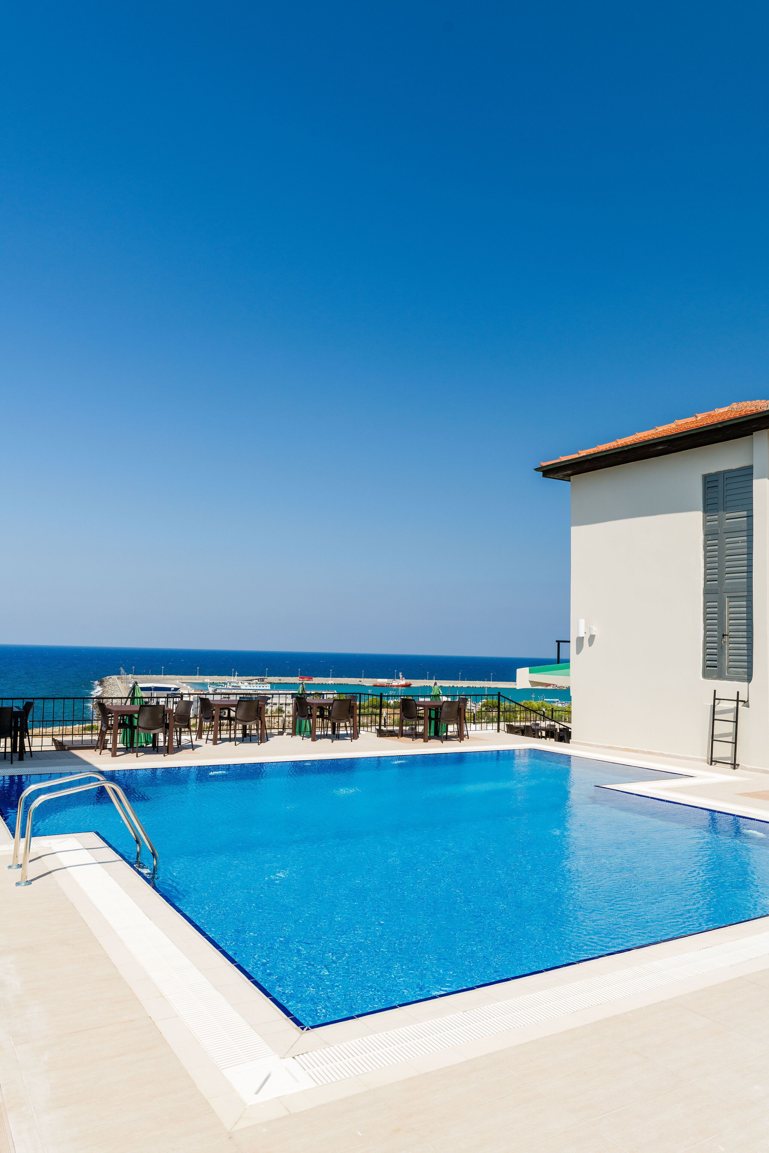 outdoor pool, open 8:00 am to 6:00 pm, pool umbrellas, pool loungers