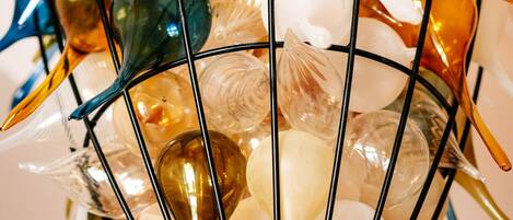 A collection of colorful glass objects displayed in a wire cage.