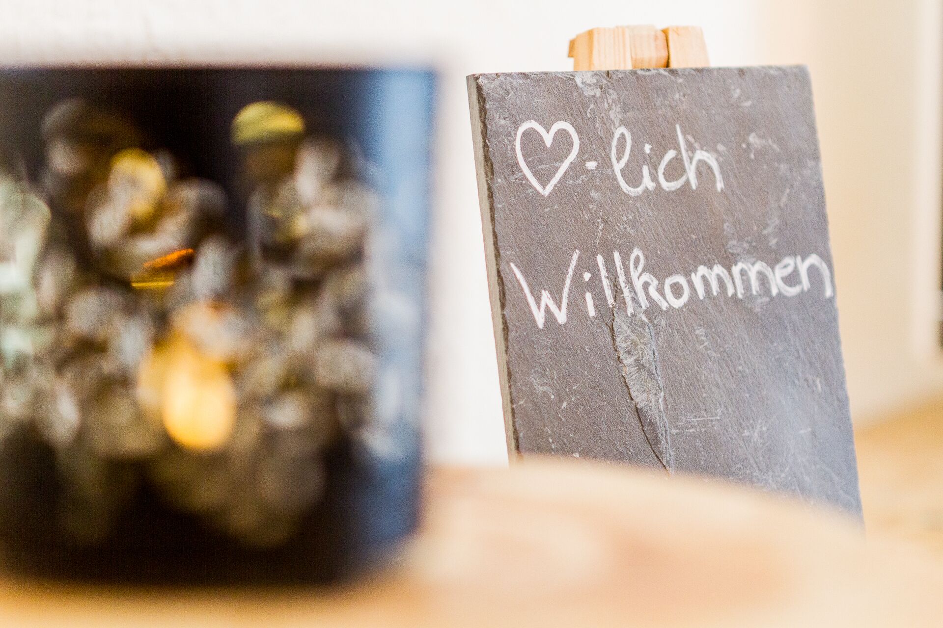A chalkboard with "Willkommen" written on it, suggesting a welcoming message.