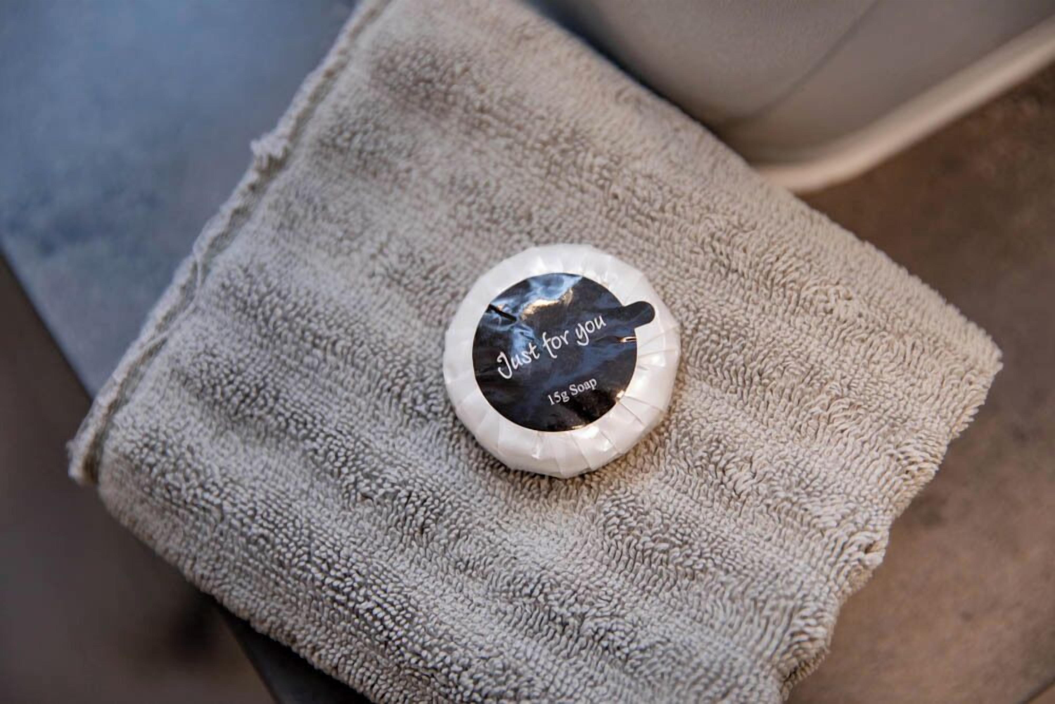 A towel with a small container on it.