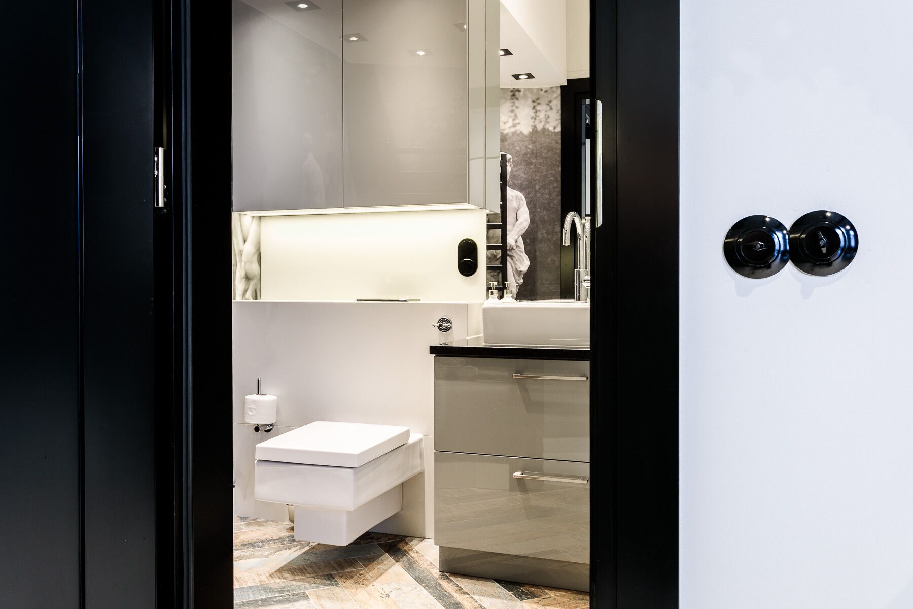 Une salle de bain moderne avec des toilettes, un lavabo et un miroir.