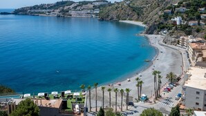A coastal hotel with a beach view, a pool area, and a parking lot. - Lovely modern villa with private heated pool (Almuñécar)