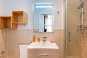 Shower, hair dryer, towels, soap