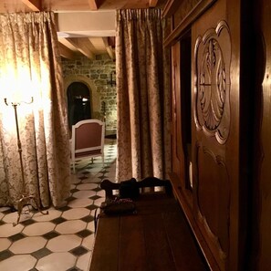 Corridors lead to rooms with stone walls and wooden doors featuring intricate carvings.