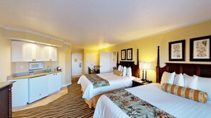 A hotel room with two beds, a kitchenette, a dining area, and a bathroom. - St Pete Beach | Couples Gulf Coast Retreat | Pool + Beach (St. Pete Beach)