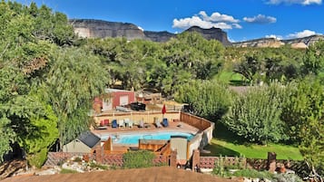Seasonal outdoor pool, open 1:00 PM to 8:00 PM, pool umbrellas