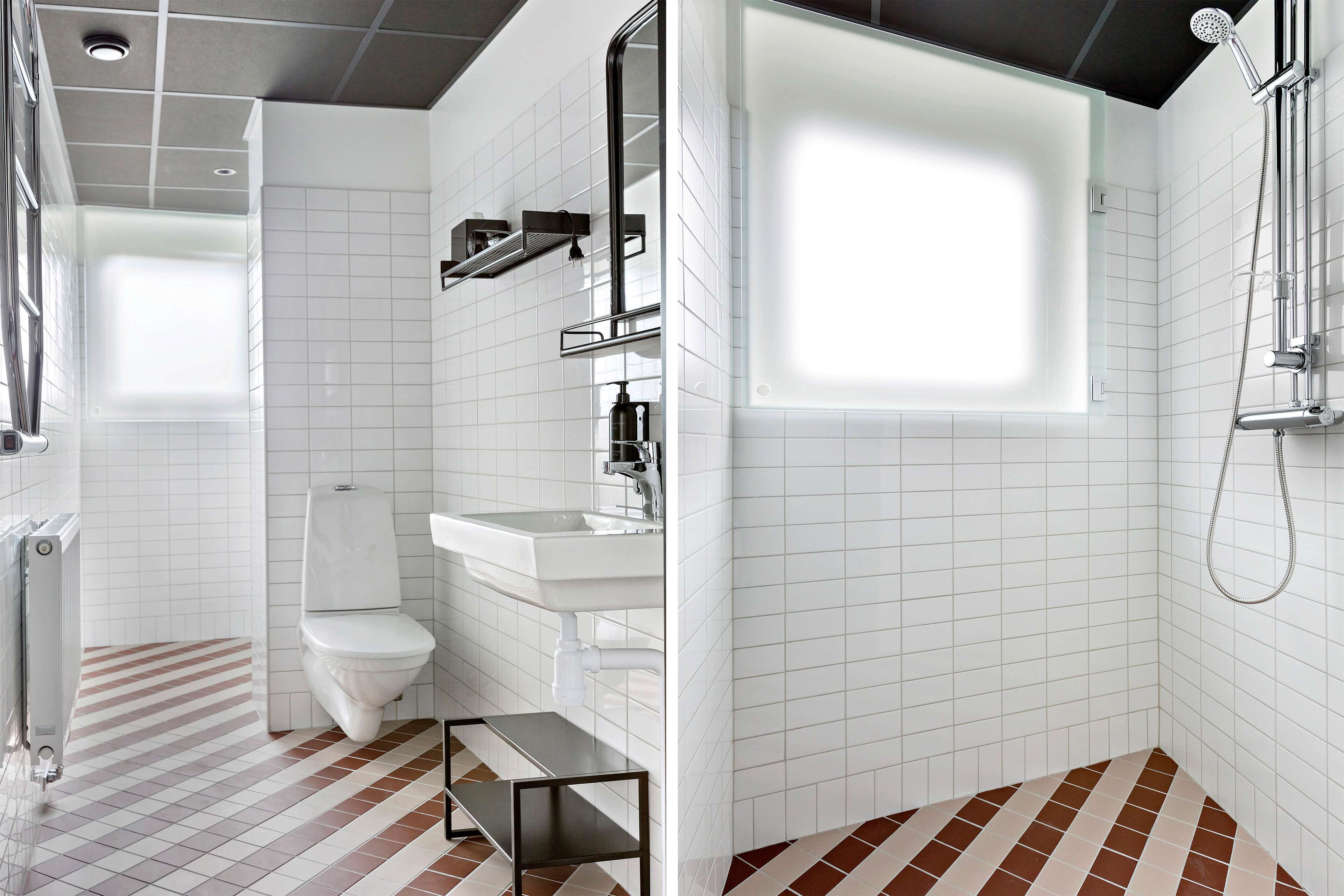 A modern bathroom with a toilet, sink, and shower.