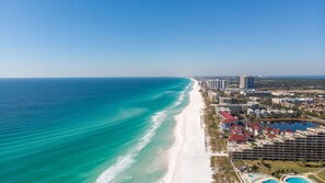 A coastal hotel with a beachfront view, multiple buildings, and a swimming pool area. - Luxury 3 floor Beach House w/ private beach access (Miramar Beach)