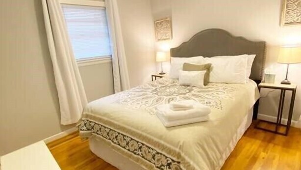 A bedroom with a bed, bedside tables, a ceiling fan, and a window with curtains. - St. Elmo Abode-3 mi to Ruby Falls (Chattanooga)