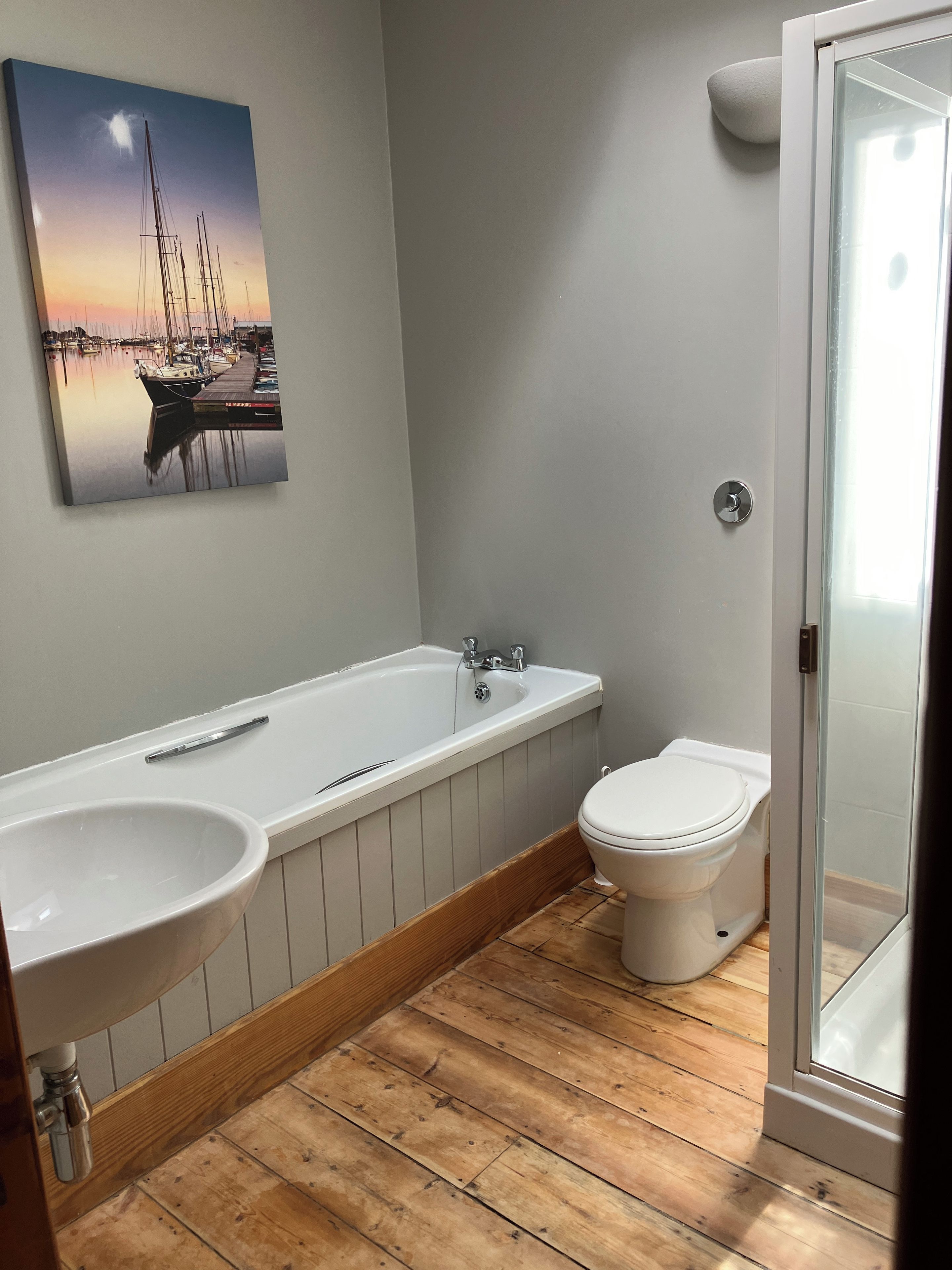 A bathroom with a bathtub, a toilet, and a shower.