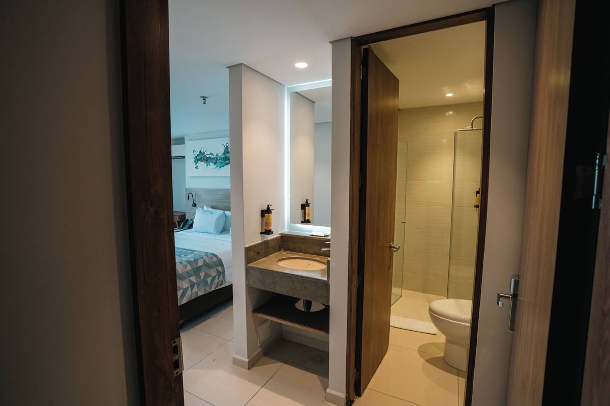 A modern bathroom with a shower, toilet, and sink.
