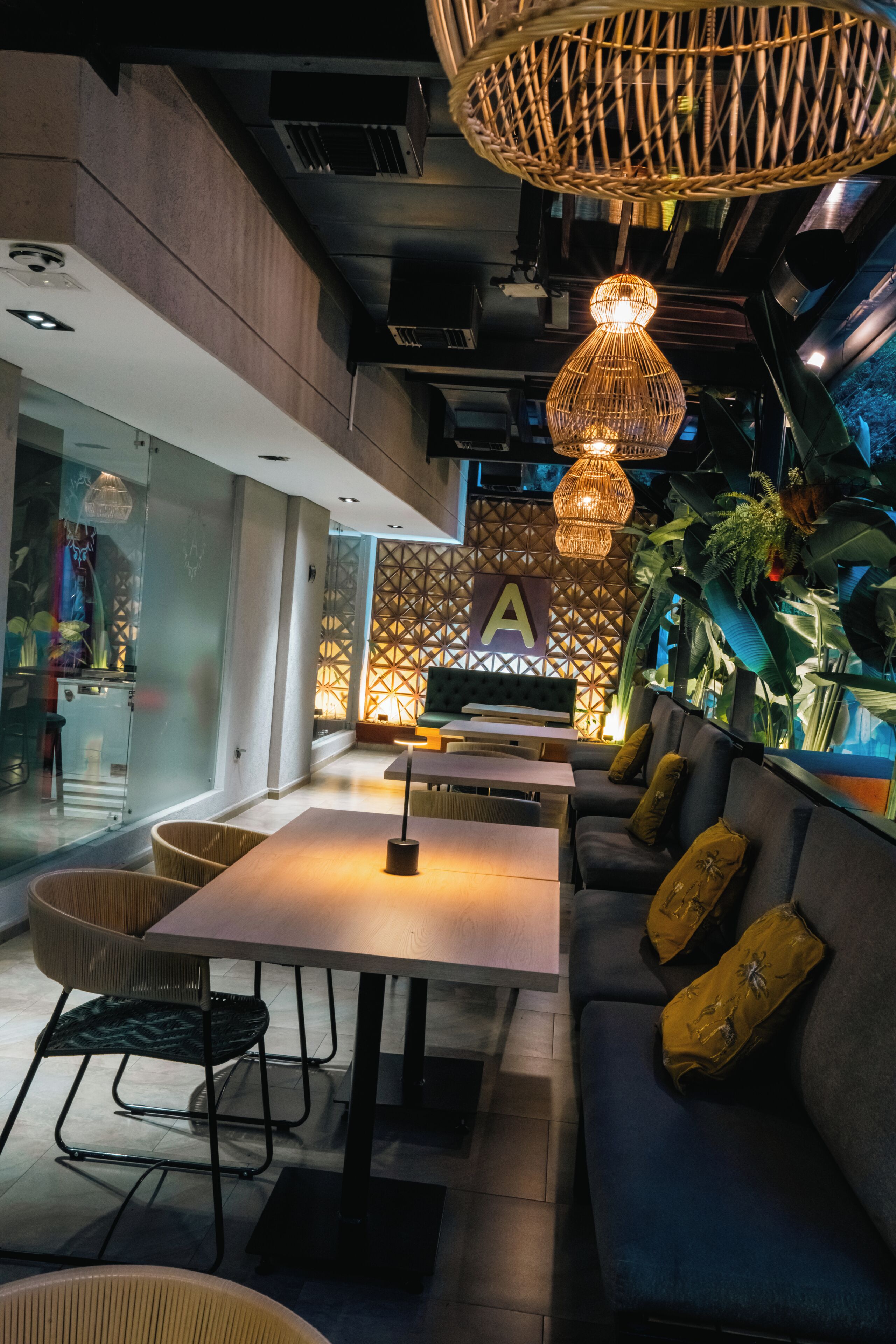A modern interior with a seating area, a table, and a decorative wall with a geometric pattern.