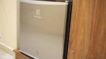 A compact, modern-looking appliance with the brand name "Electrolux" on its side, placed on a wooden platform.
