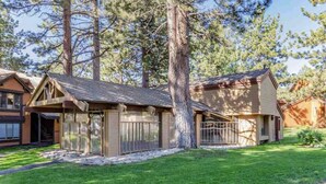 A two-story house with a covered porch and a fenced yard. - Recently remodeled! Close to everything in majestic Snowcreek Resort (Mammoth Lakes)