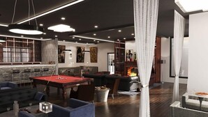 A modern living room with a pool table, comfortable seating, and a fireplace. - AC Hotel by Marriott Bridgewater (Bridgewater)