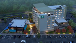 A hotel with a modern design, featuring a rooftop terrace and a parking lot. - AC Hotel by Marriott Bridgewater (Bridgewater)