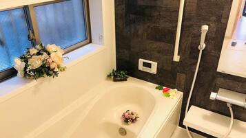 Bathtub, hair dryer, towels, soap