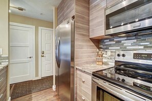 A modern kitchen with a stainless steel refrigerator, a built-in oven, and a microwave above the stove. - New To VRBO, Ski in/Out, 200 Yrds to slopes, Fireplace, shuttle to dwtn, WIFI (Breckenridge)