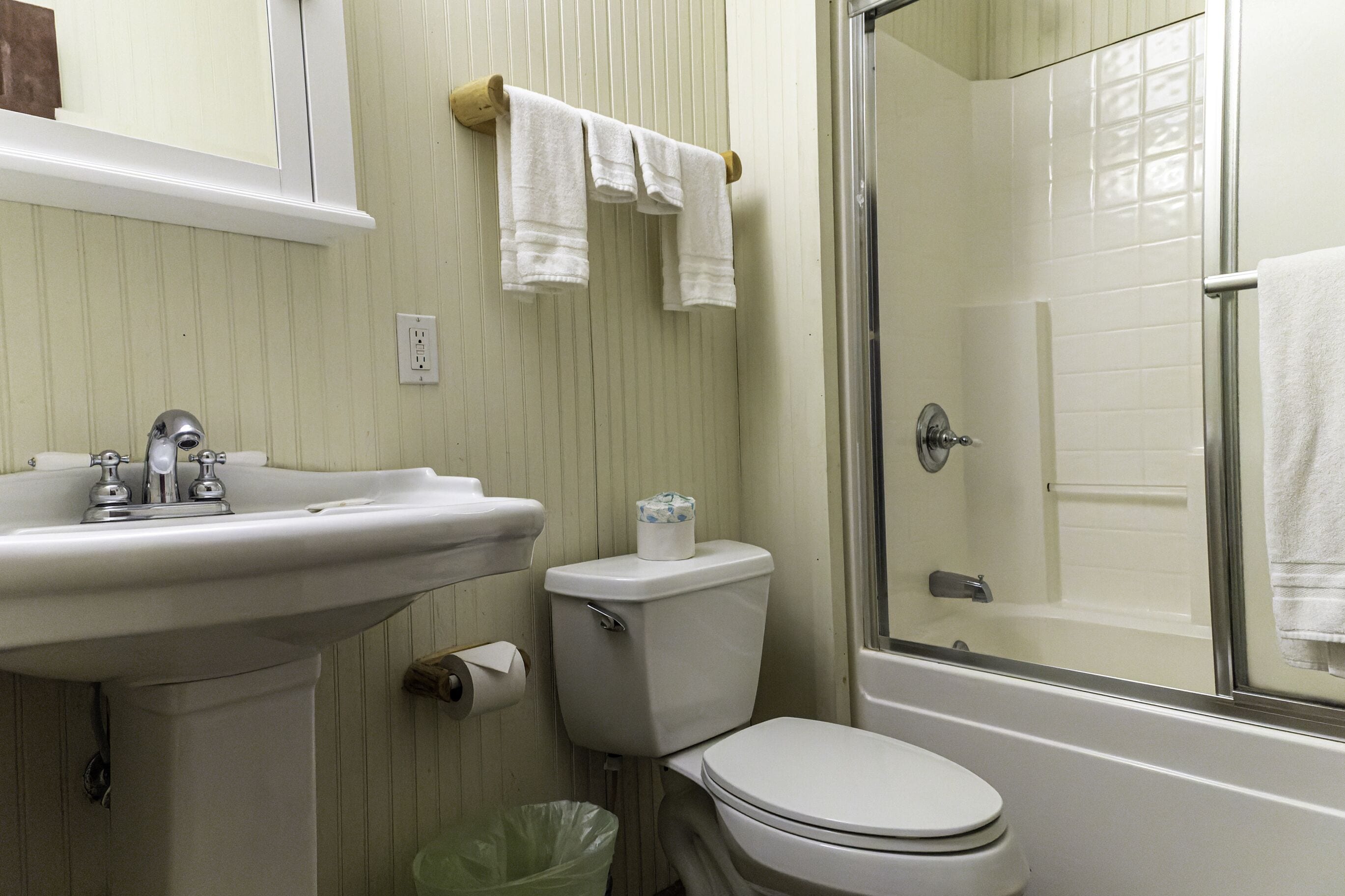 A bathroom with a sink, toilet, and shower.