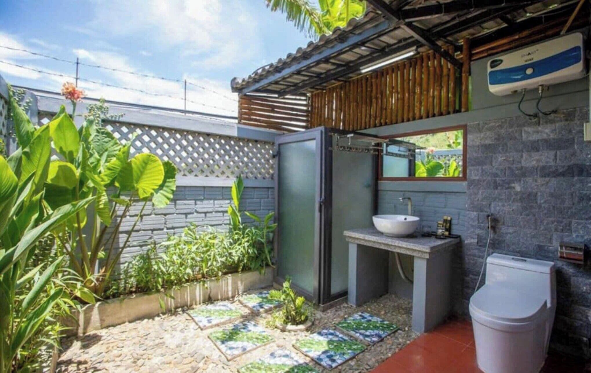 A compact bathroom with a built-in sink, a toilet, and a small window.