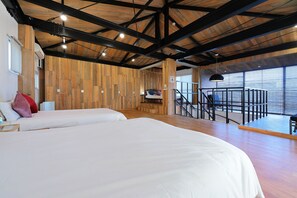 A modern hotel room with two beds, wooden walls, a balcony with a view, and a staircase. - HOTALU Universal Vacation Kan (Osaka)