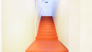 A staircase with a handrail leading to a landing.