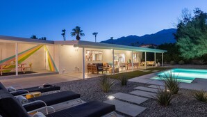 A modern house with a swimming pool, outdoor seating, and a mountain view. - Belding Bliss (Palm Springs)