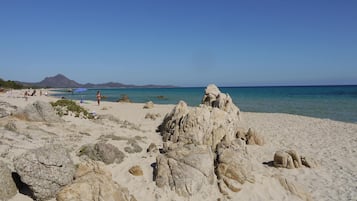 On the beach, sun-loungers