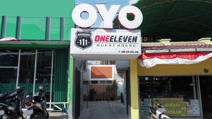 A storefront with a prominent 'OYO' sign, indicating it's a One Eleven Guesthouse. - Oyo 1454 111 Residence (Batu)