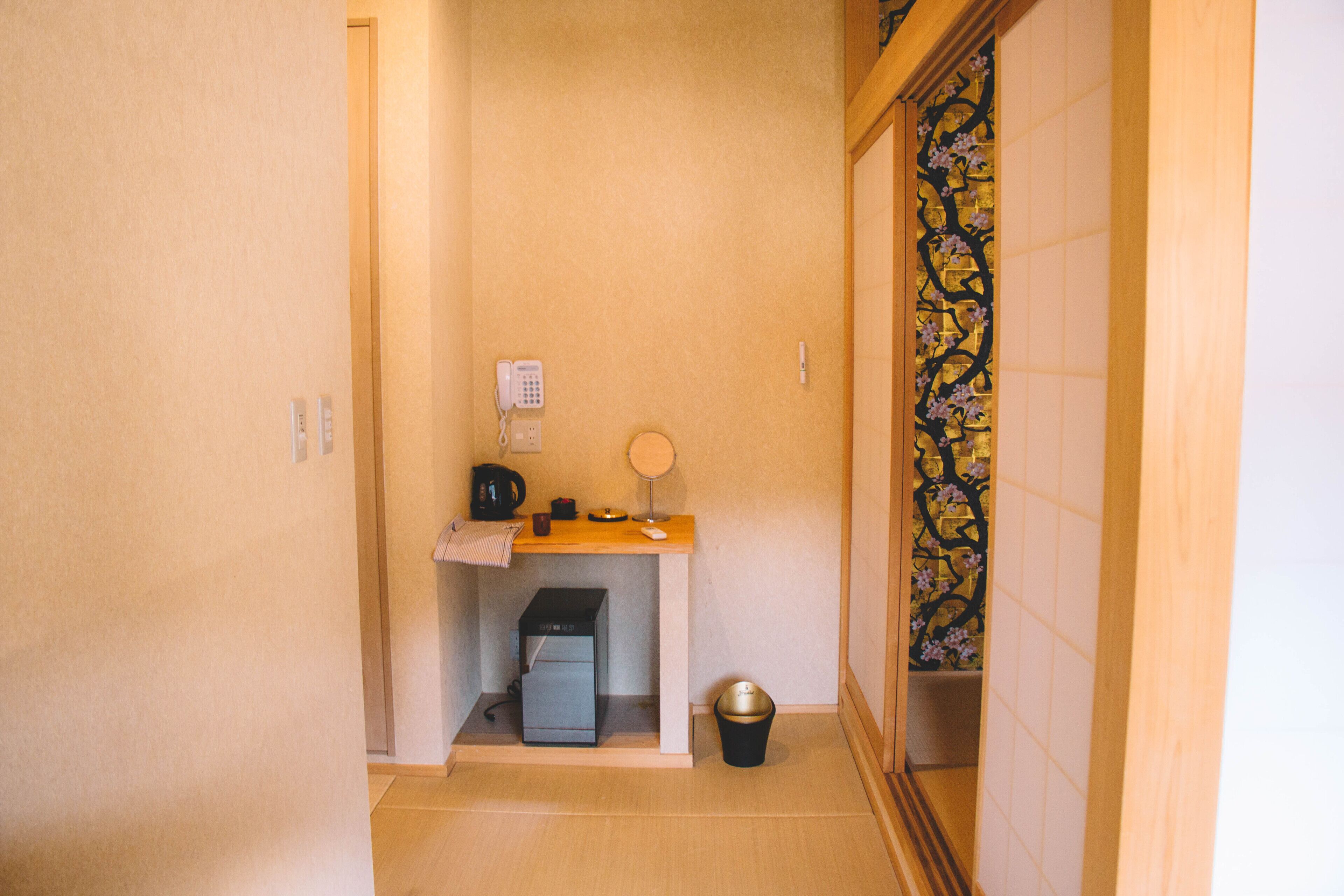 A small bathroom with a toilet, sink, and a trash bin.