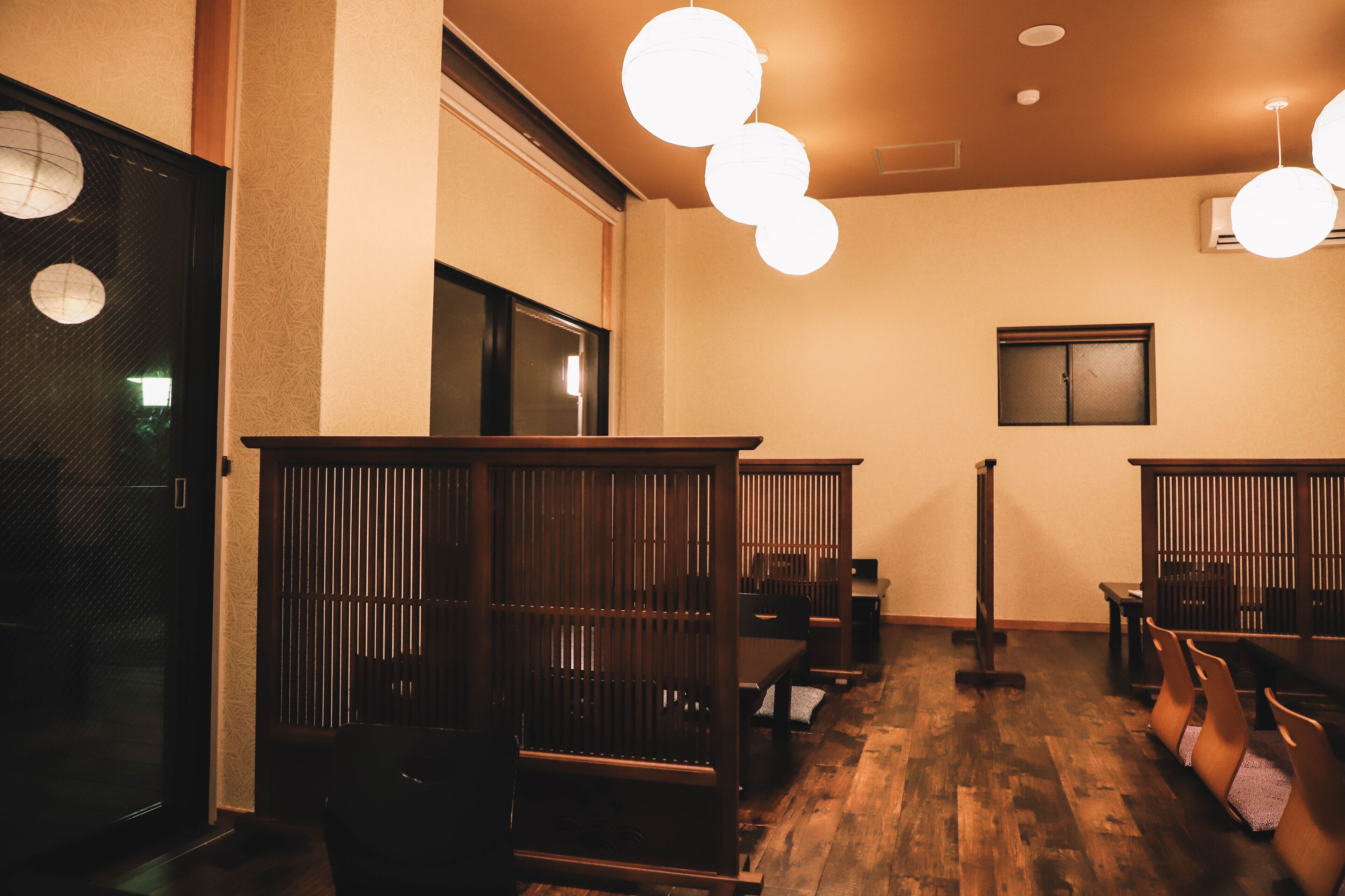 A room with wooden furniture, a bench, and a wall-mounted air conditioning unit.