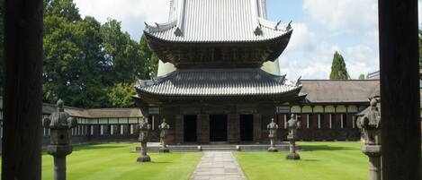 A traditional building with a symmetrical roof and a central entrance.