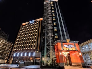 A modern hotel with a prominent ADA sign, indicating accessibility features. - APA Hotel Takaoka Ekimae (Takaoka)