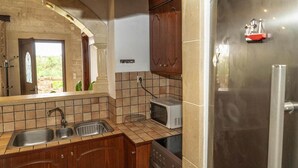 A kitchen with a stainless steel refrigerator, a microwave, and a double sink. - Modern holiday home in Stalos with balcony (Stalos)