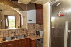 A kitchen with a stainless steel refrigerator, a microwave, and a double sink. - Modern holiday home in Stalos with balcony (Stalos)