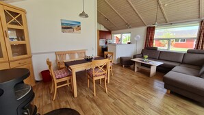 Un salon chaleureux avec des meubles en bois, une table à manger et un canapé.
