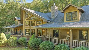 A log cabin with a porch, multiple windows, and a chimney. - Views, privacy, Kids Playhouse, Easy Access, Fast WiFi! Gated community (Waynesville)