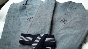 A pair of grey trousers with a dark blue striped tie.