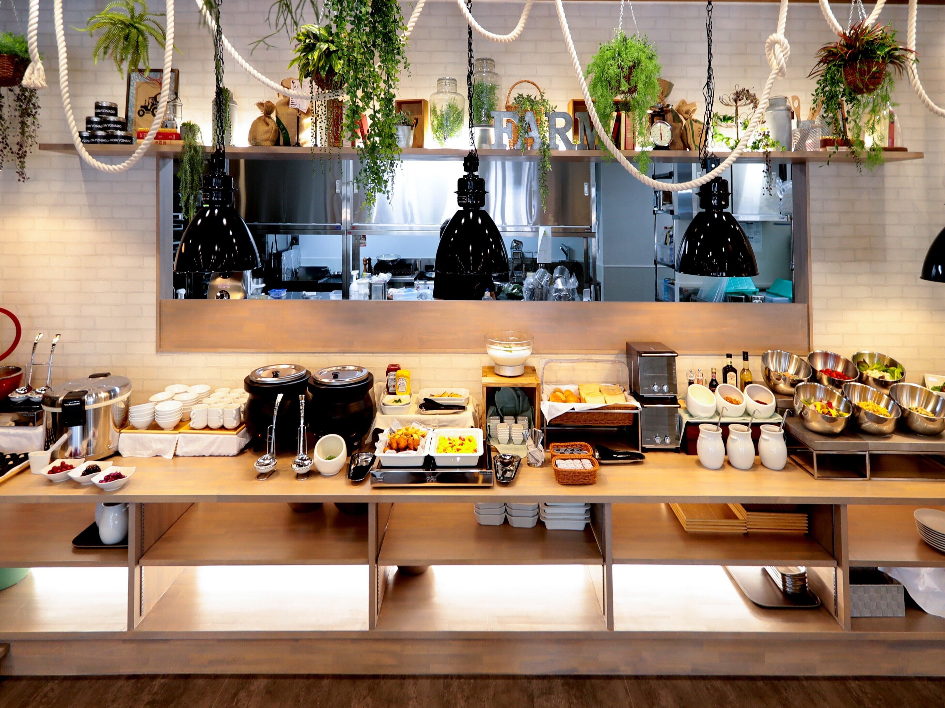 A buffet setup with various food items and condiments.