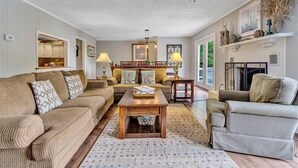 A cozy living room with a sofa, armchairs, a coffee table, and a fireplace. - SANDY BEACH & HOT TUB! Come Visit "Blue Lake Escape"! (Huddleston)