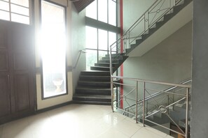 Staircase leads to an upper level with a door and tiled floor.