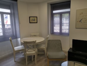 Cozy living space with a round dining table and comfortable seating for four.
