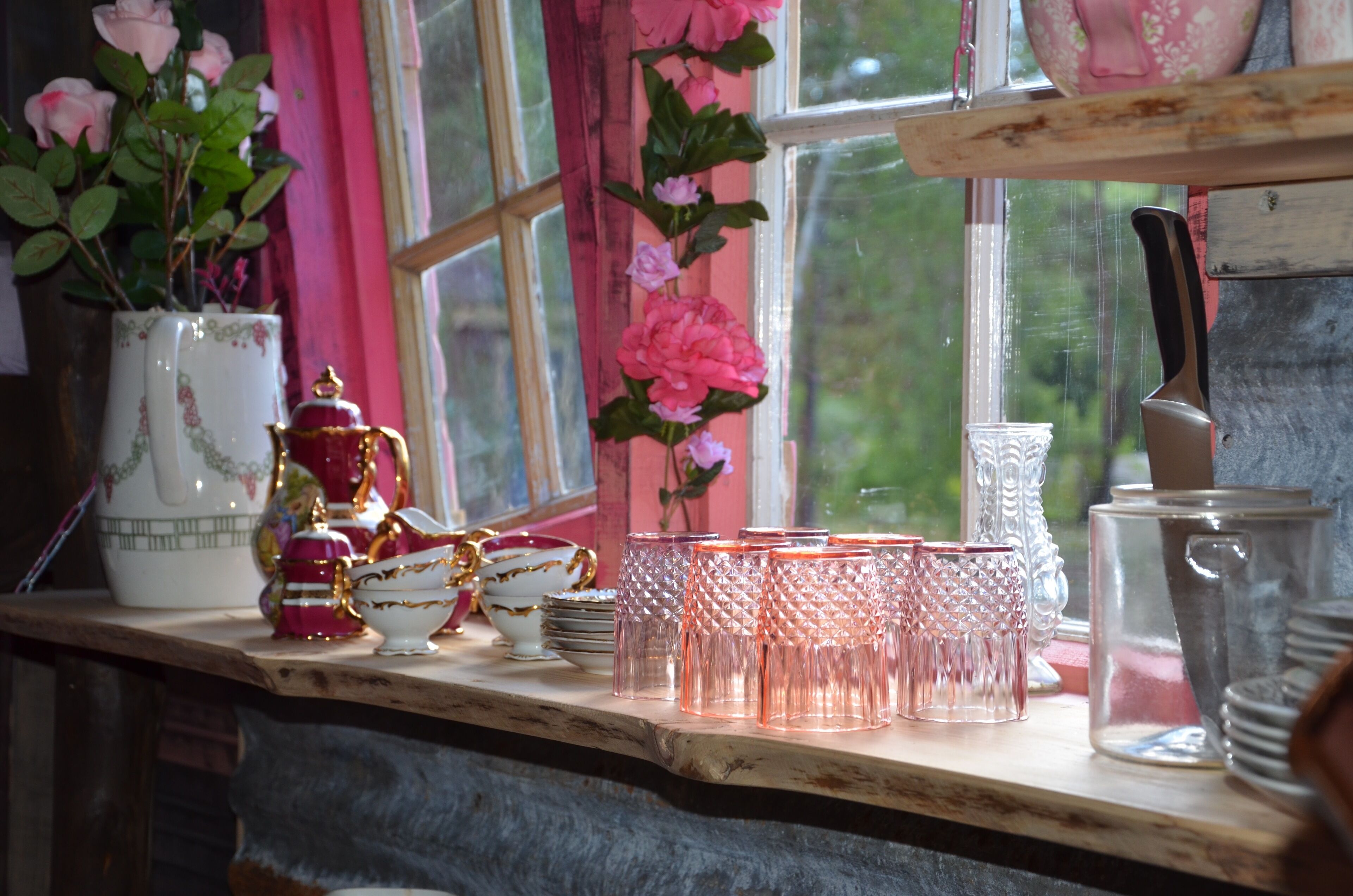 A kitchen counter with various glassware and dishes.