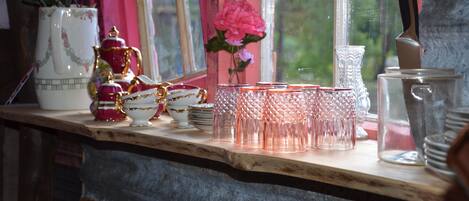 A kitchen counter with various glassware and dishes.