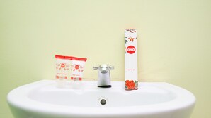 A white sink with a faucet and two toiletry items: a bottle of OYO body wash and a tube of OYO dental kit. - OYO 1639 Penginapan Anggrek Syariah 1 (Probolinggo)